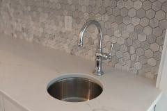 Carrara hexagon backsplash with Quartz top