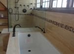 Travertine and Glass Mosaic Tub Deck and Shower